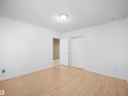 Room featuring light wood-finish flooring, white walls, and white trim - 