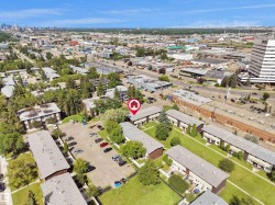 Aerial view showcasing multiple residential buildings with surrounding green spaces - 
