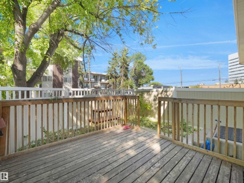 Spacious outdoor deck with natural wood flooring and coordinating wood railing - 10446 55 Avenue Nw, Edmonton, AB - Outdoor With Deck Patio Veranda