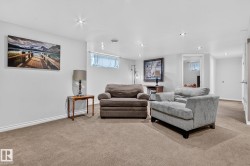 Carpeted lower level room featuring recessed lighting, painted walls, and a visible window - 