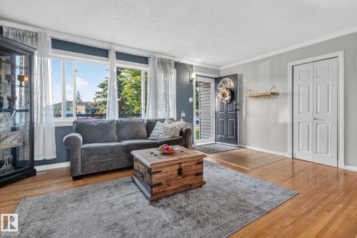 Hardwood flooring extending throughout the space - 5307 104 Avenue Nw, Edmonton, AB - Indoor Photo Showing Living Room With Fireplace