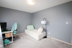 Spacious room featuring light gray wall paint, textured ceiling, light gray carpet flooring, white baseboards, and overhead flush-mount lighting - 