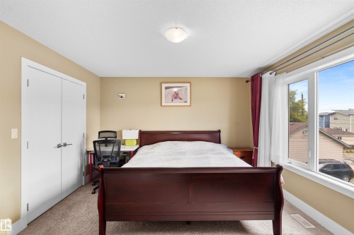 Bedroom featuring neutral wall paint, white trim, and light-colored carpet flooring - 11719 127 Street Nw, Edmonton, AB - Indoor Photo Showing Bedroom