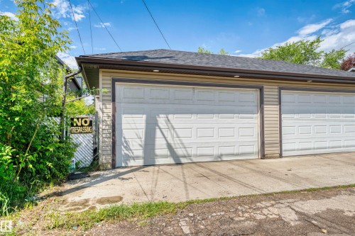 Two-car garage featuring panel-style doors and horizontal siding - 11719 127 Street Nw, Edmonton, AB - Outdoor