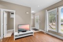 Living area with wood-finish flooring, neutral wall paint, and white trim - 11719 127 Street Nw, Edmonton, AB  - Indoor 