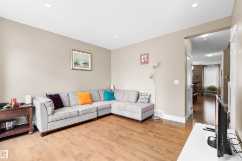 Spacious living area featuring wood-finish flooring, recessed lighting, and neutral wall tones - 11719 127 Street Nw, Edmonton, AB - Indoor Photo Showing Living Room