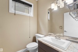 Vanity with a granite-style countertop, undermount sink, and chrome faucet - 