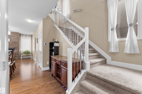 Carpeted staircase with white railings and metal spindles - 11719 127 Street Nw, Edmonton, AB - Indoor Photo Showing Other Room