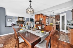 Warm wood-finish flooring extending from the dining area into the kitchen - 