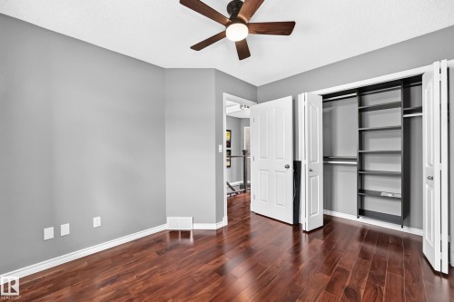 Room featuring wood-finish flooring, a ceiling fan with integrated lighting, and light grey wall paint - 12720 Hudson Way Nw, Edmonton, AB - Indoor Photo Showing Other Room