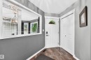 Entryway featuring tiled flooring, a white paneled door with a decorative glass insert, and white bi-fold closet doors - 12720 Hudson Way Nw, Edmonton, AB  - Indoor Photo Showing Other Room 
