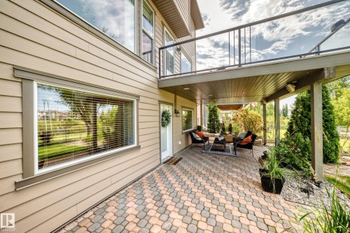 Covered patio featuring an interlocking paver surface, wood plank ceiling, and recessed lighting - 12720 Hudson Way Nw, Edmonton, AB - Outdoor With Deck Patio Veranda With Exterior