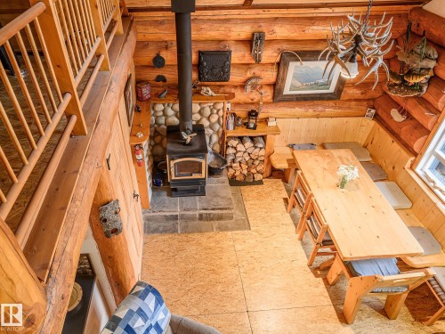Open-concept living space with log walls and exposed beams - 58227 Range Rd 70 A, Rural St. Paul County, AB - Indoor Photo Showing Other Room