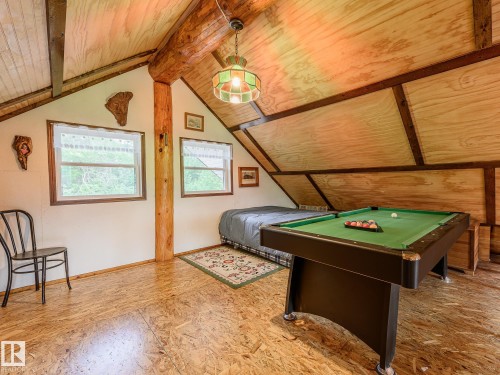 Rustic attic space with exposed wood beam, wood-finish flooring, and sloped wood-paneled ceilings - 58227 Range Rd 70 A, Rural St. Paul County, AB - Indoor Photo Showing Other Room