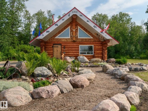 Log cabin exterior featuring a red-trimmed roofline and natural wood siding - 58227 Range Rd 70 A, Rural St. Paul County, AB - Outdoor