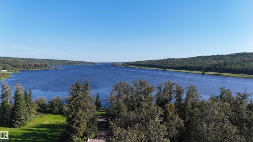 Expansive waterfront property featuring a large body of water, dense tree lines, and a clear sky - 58227 Range Rd 70 A, Rural St. Paul County, AB - Outdoor With Body Of Water With View
