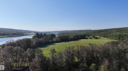 Expansive natural landscape featuring a river, mature trees, and open green fields - 58227 Range Rd 70 A, Rural St. Paul County, AB - Outdoor With Body Of Water With View