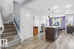 Open concept living space featuring wood-finish flooring - 
