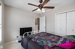Room featuring a ceiling fan with integrated lighting, textured ceilings, and light-toned wall paint - 