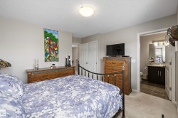 Carpeted bedroom featuring neutral wall tones and a white textured ceiling - 