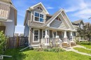 Gable-front home featuring gray siding with white trim accents and a covered porch - 4688 Crabapple Run Sw, Edmonton, AB  - Outdoor With Facade 