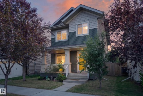 Two-story residence featuring a covered front porch, vertical siding, horizontal siding, and shake siding in a multi-tone color scheme - 3139 Carpenter Landing Sw, Edmonton, AB - Outdoor