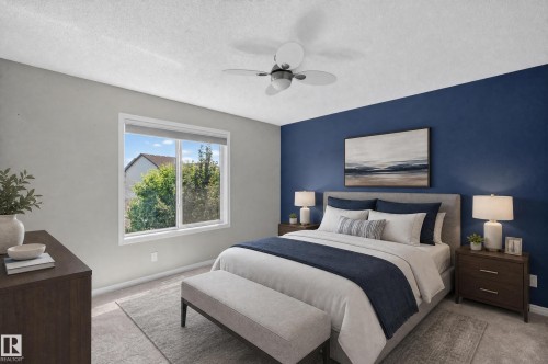 Bedroom featuring a prominent accent wall in blue, light gray wall finishes, a white window frame, and a ceiling fan with integrated lighting - 3139 Carpenter Landing Sw, Edmonton, AB - Indoor Photo Showing Bedroom