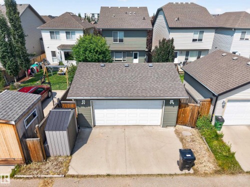 Rear-facing two-car garage with concrete driveway and asphalt shingle roof - 3139 Carpenter Landing Sw, Edmonton, AB - Outdoor