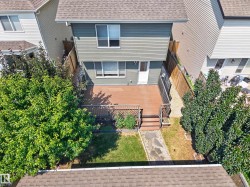 Green siding exterior with a brown shingle roof - 