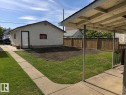 Expansive backyard featuring a partial grass lawn, a section of prepared soil, and a wood privacy fence - 12134 96 Street, Edmonton, AB  - Outdoor 