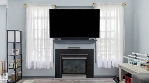 #18 4900 62 St, Beaumont, AB - Indoor Photo Showing Living Room With Fireplace