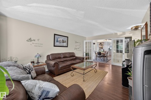 Spacious living area featuring wood-finish flooring, light-toned walls, and recessed lighting - 8310 99 Avenue, Fort Saskatchewan, AB - Indoor Photo Showing Living Room