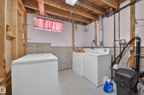 Utility space featuring exposed wood framing, concrete foundation walls, and a finished ceiling - 8310 99 Avenue, Fort Saskatchewan, AB - Indoor Photo Showing Laundry Room