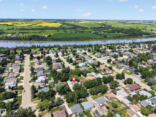 Residential neighborhood with mature trees, established streets, and homes featuring various roof styles - 8310 99 Avenue, Fort Saskatchewan, AB - Outdoor With View