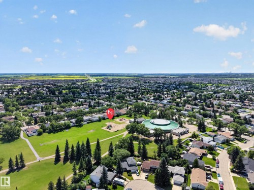 Aerial view showcasing an established neighborhood with extensive green spaces and mature trees - 8310 99 Avenue, Fort Saskatchewan, AB - Outdoor With View