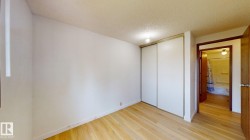 Light wood-finish flooring with white baseboards and neutral wall tones - 