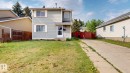 Two-story residence featuring light blue siding with white trim, a concrete driveway, and a front lawn - 4912 34A Avenue, Edmonton, AB  - Outdoor 