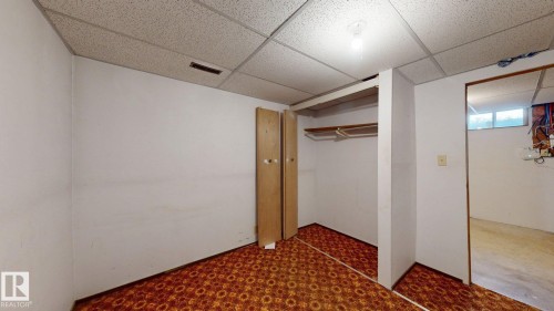 Room featuring patterned flooring, white walls, and a drop ceiling - 4912 34A Avenue, Edmonton, AB - Indoor Photo Showing Other Room