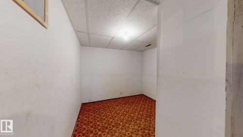Room featuring patterned carpeting, white walls, drop ceiling, and overhead lighting - 4912 34A Avenue, Edmonton, AB - Indoor Photo Showing Other Room