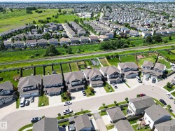 Aerial representation of a residential neighborhood featuring detached homes with asphalt shingle roofing - 