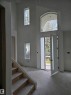 Two-story entryway featuring a tall arched window and multiple vertical windows - 9216 91 Street, Edmonton, AB  - Indoor Photo Showing Other Room 