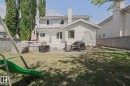 Expansive backyard featuring a multi-level deck, mature trees, and a wooden privacy fence - 11347 10 Avenue, Edmonton, AB  - Outdoor 