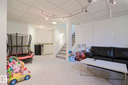 Versatile lower-level space featuring light-toned carpeting and a drop ceiling - 