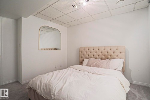 Recessed lighting illuminates this room, featuring carpet flooring, painted walls, and a tiled ceiling - 11347 10 Avenue, Edmonton, AB - Indoor Photo Showing Bedroom