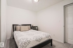 White walls, gray carpet flooring, white baseboards, and a white interior door - 