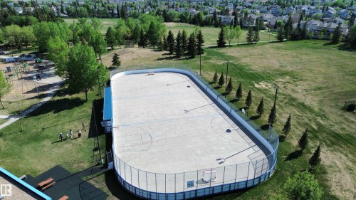 Expansive outdoor rink with basketball markings and surrounding safety netting - 11347 10 Avenue, Edmonton, AB - Outdoor
