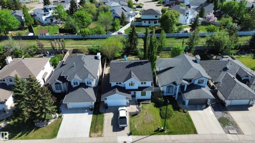 Two-story residence with a light-colored exterior and dark shingle roofing - 11347 10 Avenue, Edmonton, AB - Outdoor With Facade