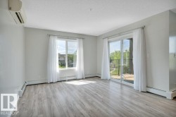Spacious living room with sliding doors to access the spacious balcony with south and west exposures, perfect for loads of light and sunshine. - 