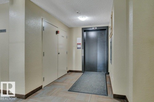 Elevator access in a hallway - #201 534 Watt Bv Sw, Edmonton, AB - Indoor Photo Showing Other Room