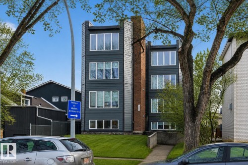 Modern four-story building featuring dark gray siding and white-framed windows - #201 10743 107 St Nw, Edmonton, AB - Outdoor With Facade